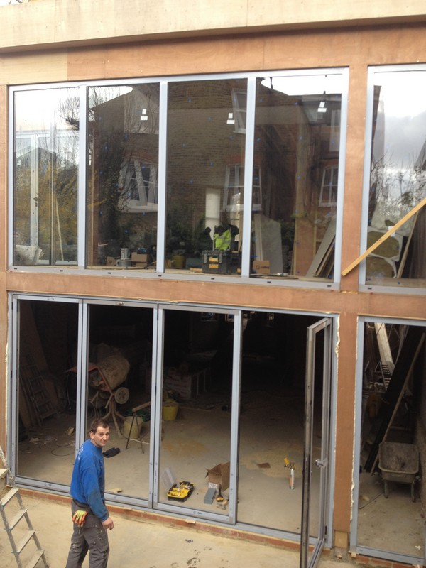 Aluminium bi-fold doors with two-storey glazing in New Malden