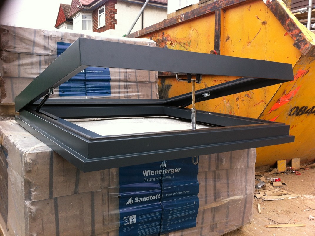 Opening flat roof skylight in anthracite grey installed in New Malden